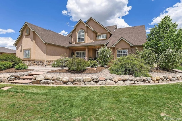 view of front of home with stucco siding and a front yard