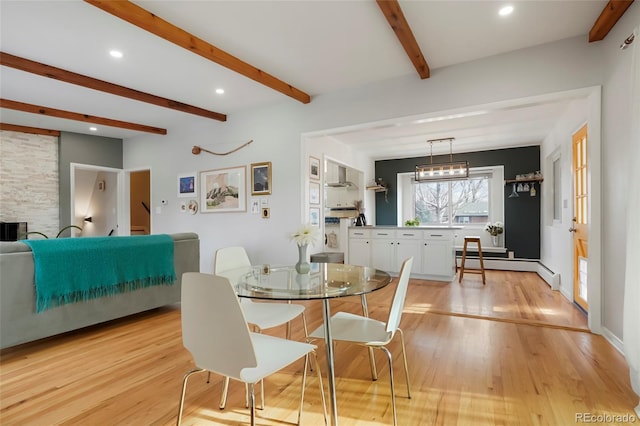 dining area with a baseboard heating unit, beamed ceiling, light wood-type flooring, and recessed lighting