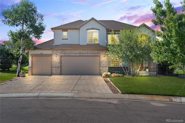1511 Peninsula Cir, Castle Rock, CO 80104 - traditional-style house featuring a yard, driveway, stucco siding, brick siding, and a garage