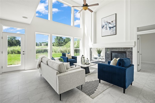 1511 Peninsula Cir, Castle Rock, CO 80104 - living area with light marble finish floors, a high ceiling, a ceiling fan, and a premium fireplace