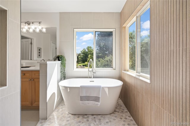 1511 Peninsula Cir, Castle Rock, CO 80104 - bathroom with vanity, a soaking tub, tile patterned flooring, and tile walls
