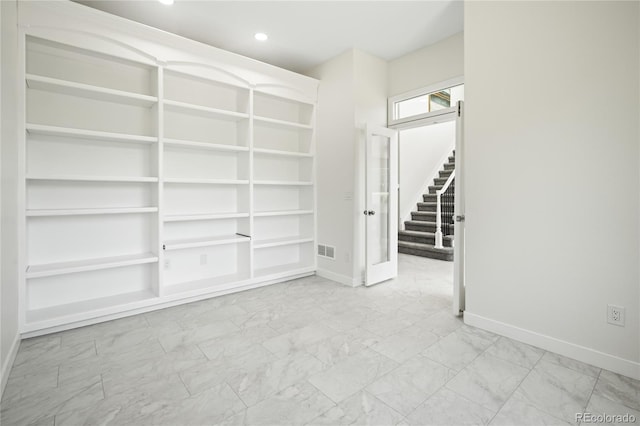 1511 Peninsula Cir, Castle Rock, CO 80104 - spare room with marble finish floors, built in shelves, stairs, and recessed lighting