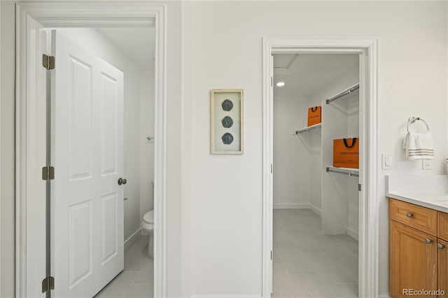 1511 Peninsula Cir, Castle Rock, CO 80104 - bathroom featuring vanity, tile patterned flooring, and a walk in closet