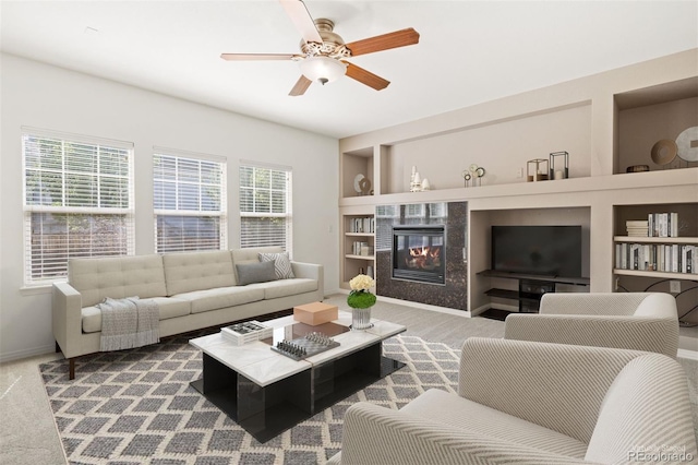 carpeted living room featuring ceiling fan and built in features