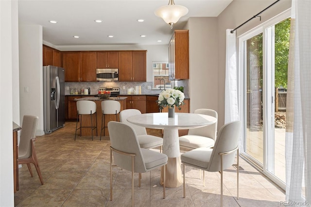 tiled dining space with a wealth of natural light and sink