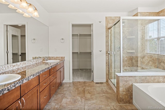 bathroom with tile patterned flooring, vanity, and shower with separate bathtub