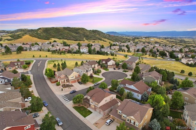 aerial view at dusk featuring a mountain view