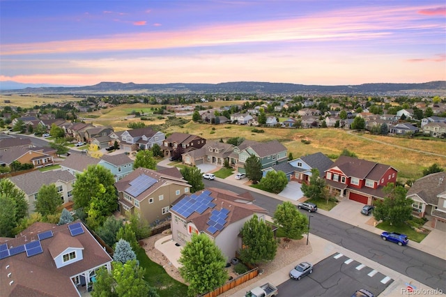 aerial view at dusk featuring a mountain view