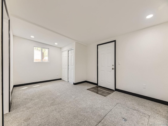 unfurnished bedroom featuring carpet, baseboards, a closet, recessed lighting, and lofted ceiling
