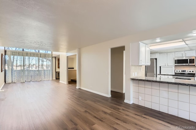 unfurnished living room featuring dark wood-type flooring