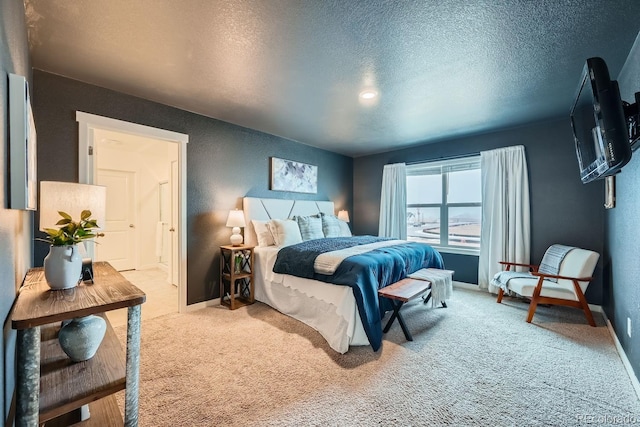 bedroom featuring a textured ceiling and carpet