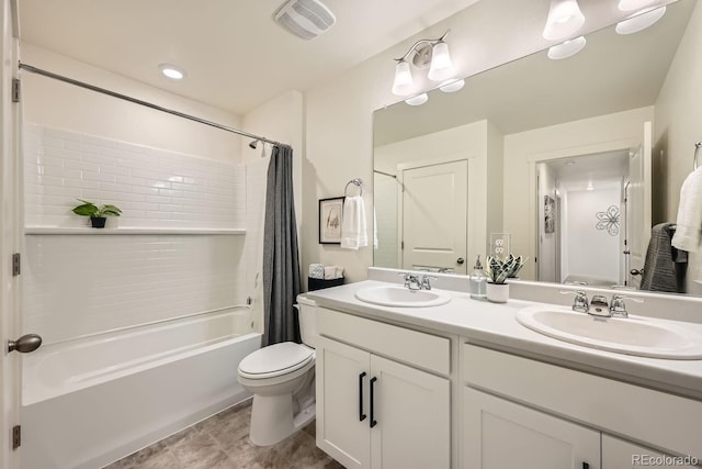 full bathroom with vanity, shower / tub combo with curtain, and toilet