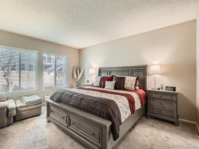 bedroom featuring light colored carpet and a textured ceiling