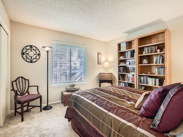 carpeted bedroom featuring a textured ceiling