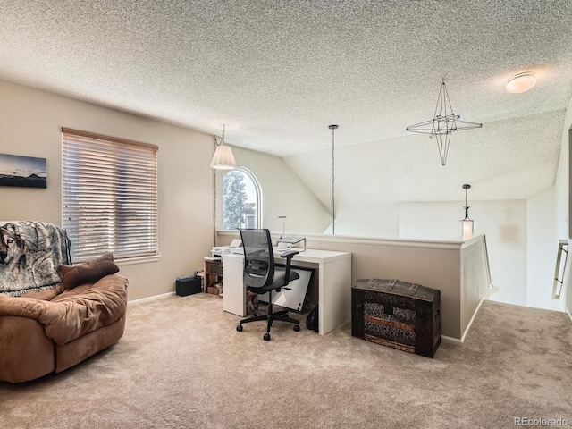 office space featuring a textured ceiling, light colored carpet, and vaulted ceiling