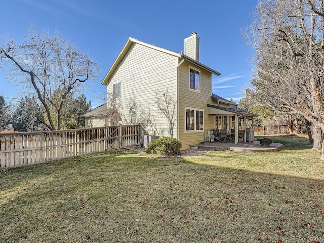 back of property with a patio and a lawn