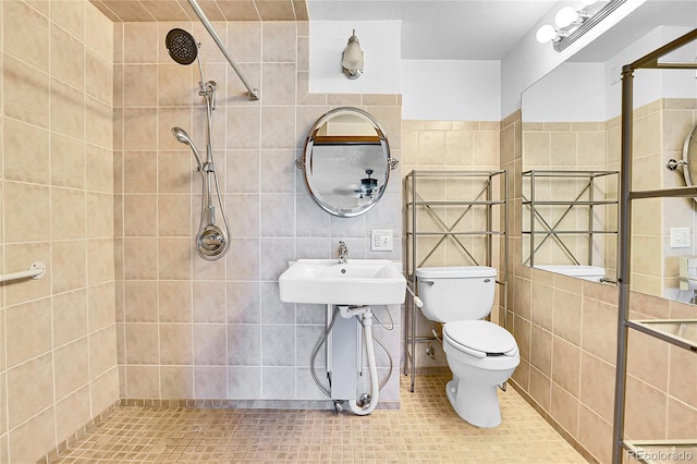 13270 W 65th Ave, Arvada, CO 80004 - bathroom featuring a tile shower, toilet, tile walls, tile patterned flooring, and a sink