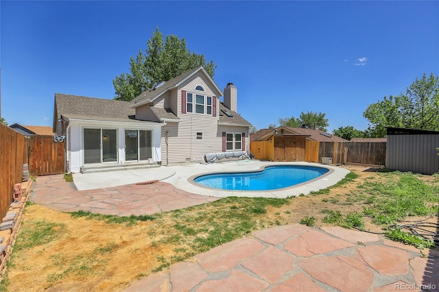 13270 W 65th Ave, Arvada, CO 80004 - view of pool featuring a shed, a fenced backyard, a patio, and an outdoor structure