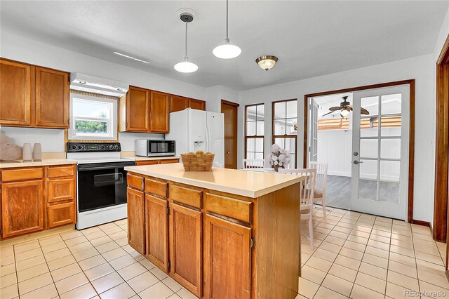 13270 W 65th Ave, Arvada, CO 80004 - kitchen featuring electric stove, stainless steel microwave, ceiling fan, light tile patterned flooring, and light countertops