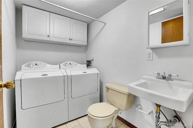13270 W 65th Ave, Arvada, CO 80004 - clothes washing area with washing machine and dryer, a textured ceiling, and light tile patterned floors