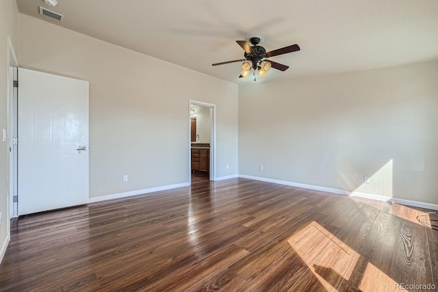 empty room with dark hardwood / wood-style floors and ceiling fan