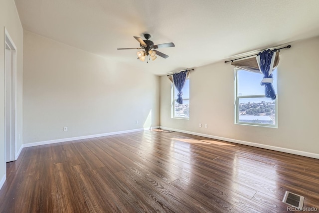 spare room featuring dark hardwood / wood-style floors and ceiling fan