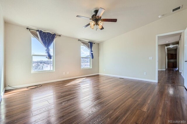 unfurnished room with ceiling fan and dark hardwood / wood-style flooring