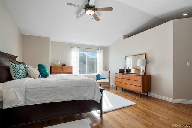 bedroom featuring baseboards, lofted ceiling, a ceiling fan, and light wood finished floors