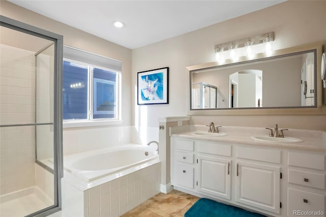 bathroom with a shower stall, a bath, double vanity, and a sink