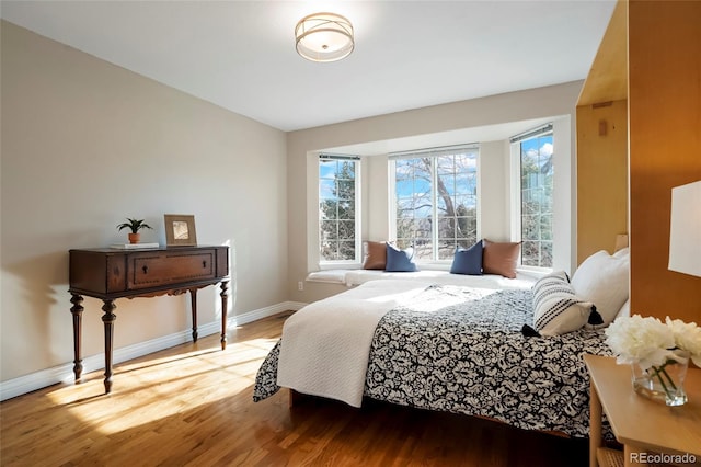 bedroom featuring wood finished floors and baseboards