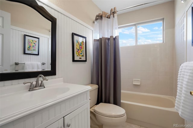 bathroom featuring vanity, toilet, and shower / bath combo with shower curtain