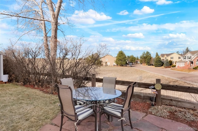 view of patio / terrace featuring outdoor dining space and a residential view