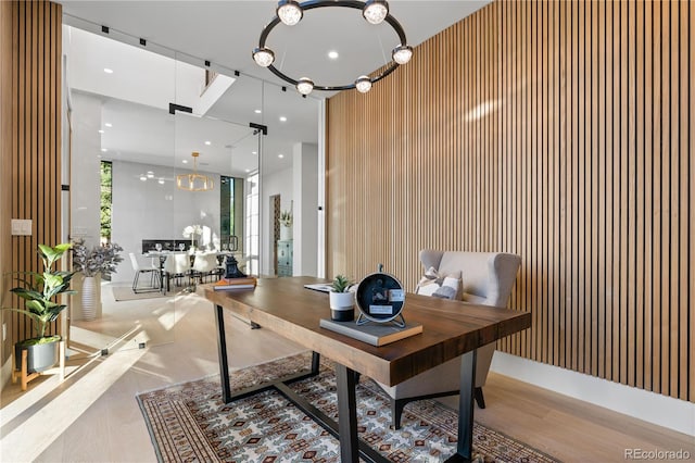 home office with wood walls and a chandelier