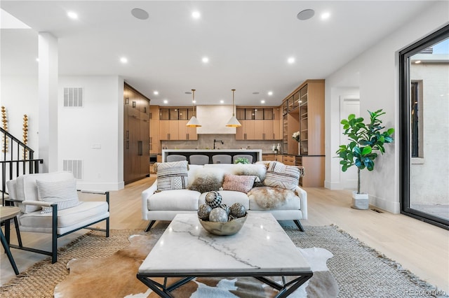 living room featuring light hardwood / wood-style floors and sink