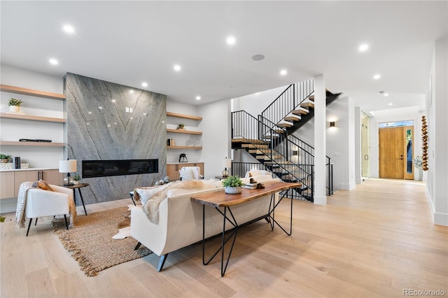 living room with light hardwood / wood-style floors and a premium fireplace