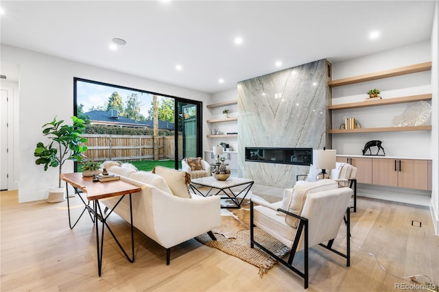 living room with light hardwood / wood-style floors and a fireplace