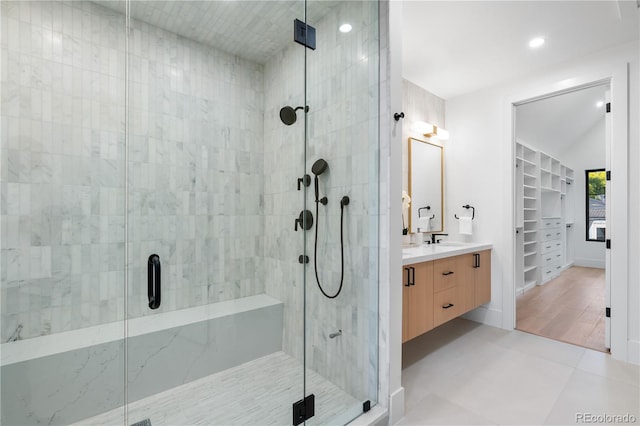 bathroom featuring an enclosed shower, hardwood / wood-style flooring, and vanity