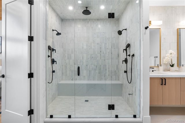 bathroom featuring vanity, tile walls, and a shower with shower door