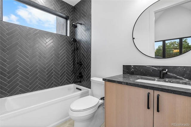 full bathroom with tile patterned flooring, tiled shower / bath combo, vanity, and toilet