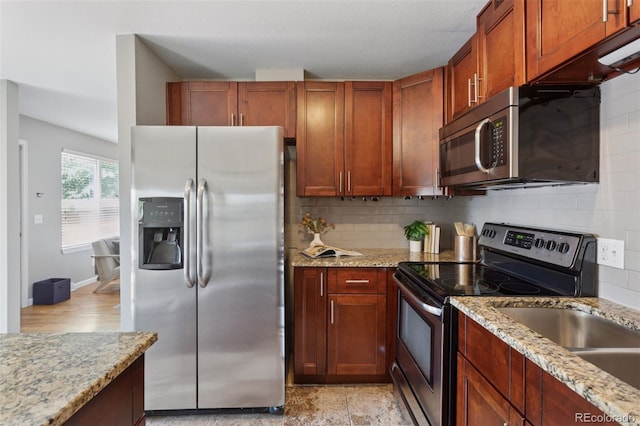 2854 N Lowell Blvd, Denver, CO 80211 - kitchen with stainless steel appliances, backsplash, and light stone countertops