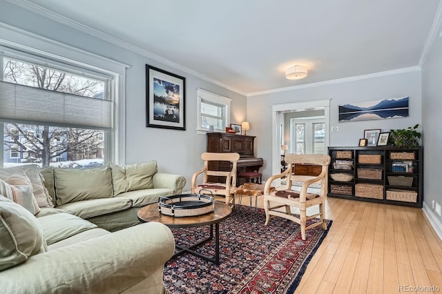 living room with plenty of natural light, ornamental molding, and wood-type flooring