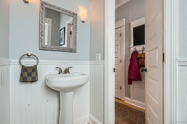 bathroom with a wainscoted wall and a sink