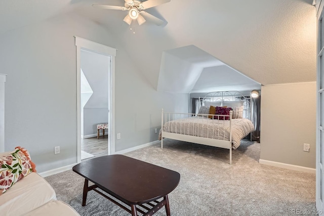 bedroom featuring baseboards, vaulted ceiling, a ceiling fan, and light colored carpet