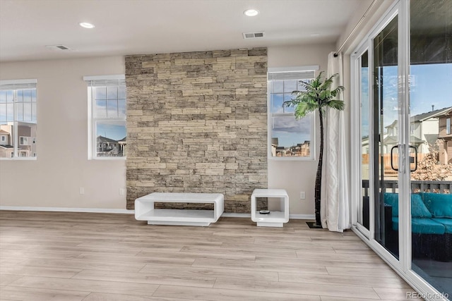 interior space with light wood-style floors, baseboards, visible vents, and recessed lighting