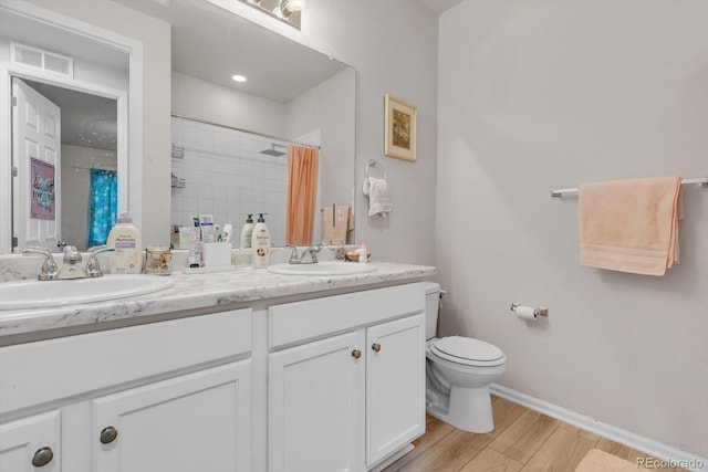 full bath with visible vents, a sink, a tile shower, and double vanity