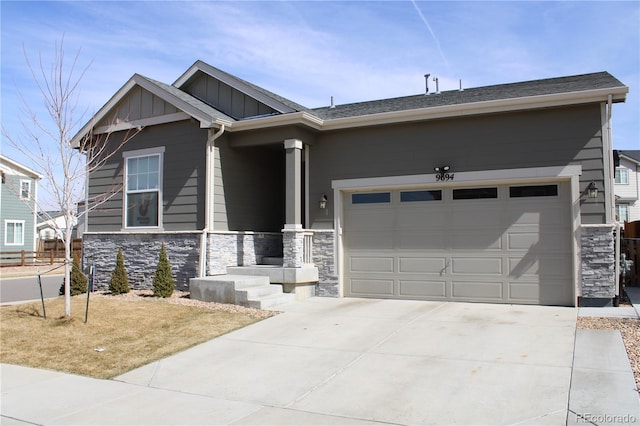 craftsman-style home featuring stone siding, board and batten siding, concrete driveway, and an attached garage