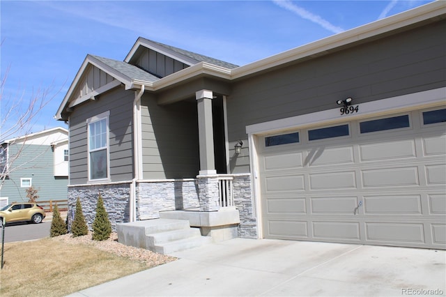 view of front of property featuring stone siding, roof with shingles, board and batten siding, concrete driveway, and a garage