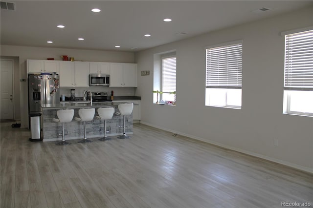 kitchen featuring stainless steel appliances, plenty of natural light, and visible vents