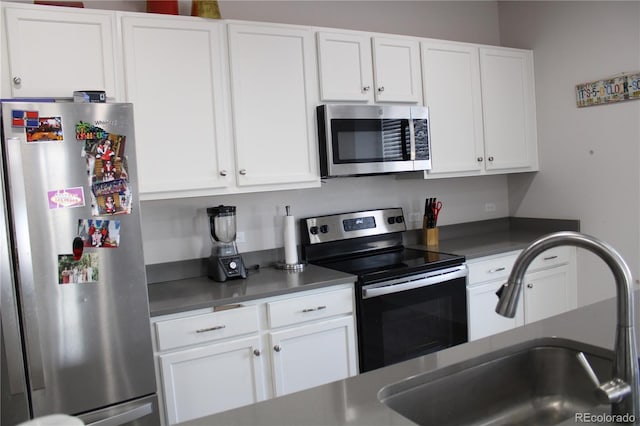 kitchen with white cabinetry, appliances with stainless steel finishes, and a sink