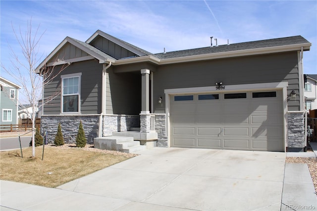 9694 Truckee St, Commerce City, CO 80022 - view of front of house featuring stone siding, board and batten siding, a garage, and driveway